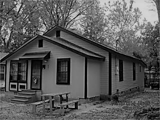 House in South Carolina pictured at an angle that shows the front and side only, Black and White
